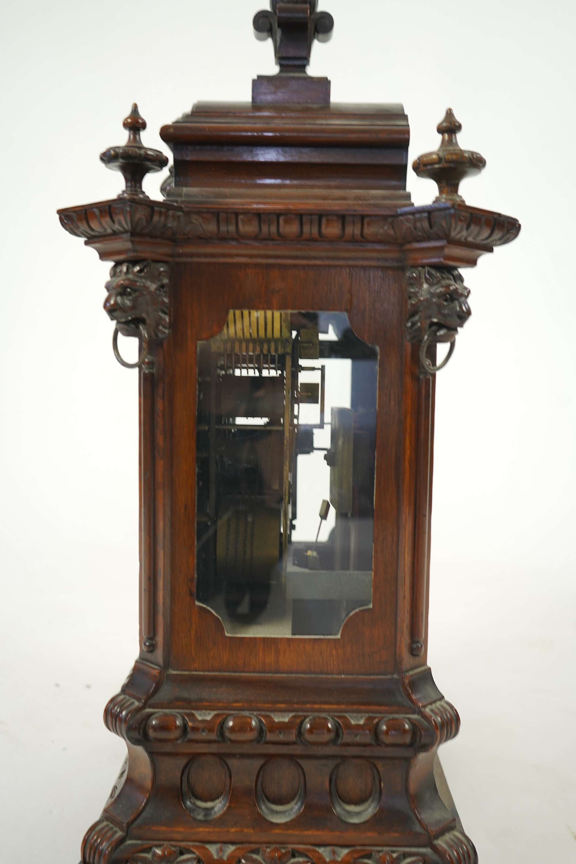 A late 19th century carved oak triple fusee bracket clock